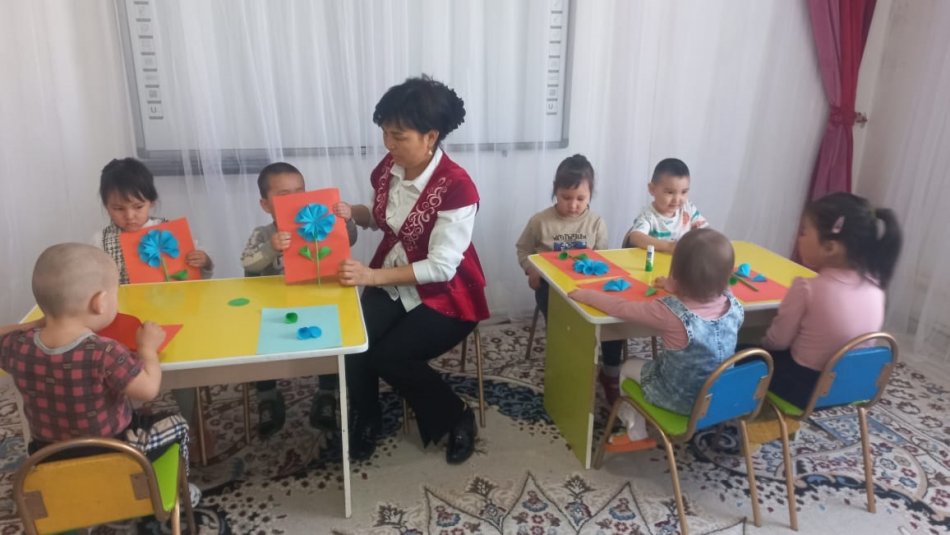 "Анама сыйлық" Мақсаты:Гүл сабағын, жапырағын, күлтелерін қиып алып, әдемі гүл құрастырып жапсыру.Әсемдікке баулу, үлкендерге ықылас білдіру.